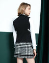 Women's zip-up tweed vest with padding, in black and white color blocking.