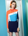 Women's long-sleeve top, in orange, white and blue color blocking.