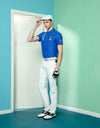 Men's short sleeve polo, in blue, with white trims and yellow slogan print. 