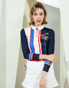Women's A-line skirt, in white, with flared hem, and scarf decoration.