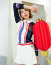 Women's A-line skirt, in white, with flared hem, and scarf decoration.