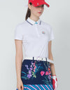 Women's short sleeve polo, in white, floral embroidery on chest and sleeves.