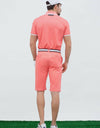 Men's short sleeve polo, with black trim, orange and white color blocking.