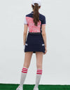 Women's short sleeve polo, in navy and white color blocking, with red stripes.