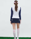 Women's knitted vest with stand collar, in pink and navy color blocking.