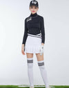 Women's A-Line skirt with pleated hem, in white and black color blocking, and wrapped waist. 