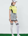 Women's short sleeve polo, in yellow, with black color blocking on both sides.