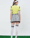 Women's short sleeve polo, in yellow, with black color blocking on both sides.