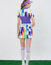 Women's purple short sleeve polo, with rainbow blast print.