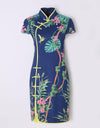 Women's navy mid-length cheongsam, with yellow pleated lining, in floral print.