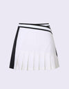 Women's A-Line skirt with pleated hem, in white and black color blocking, and wrapped waist. 