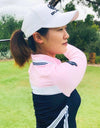 Women's long sleeve polo, in pink and navy color blocking.